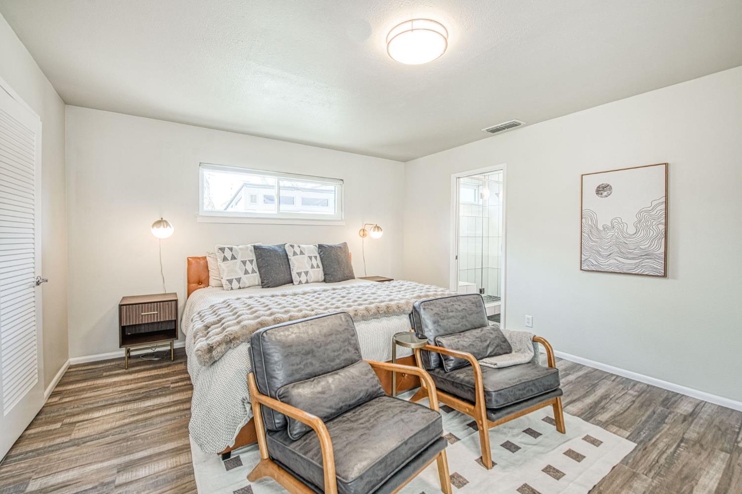1527 West San Ramon Avenue Fresno, CA 93711 - Photo 29 of 55 a bedroom with a bed and wooden floor