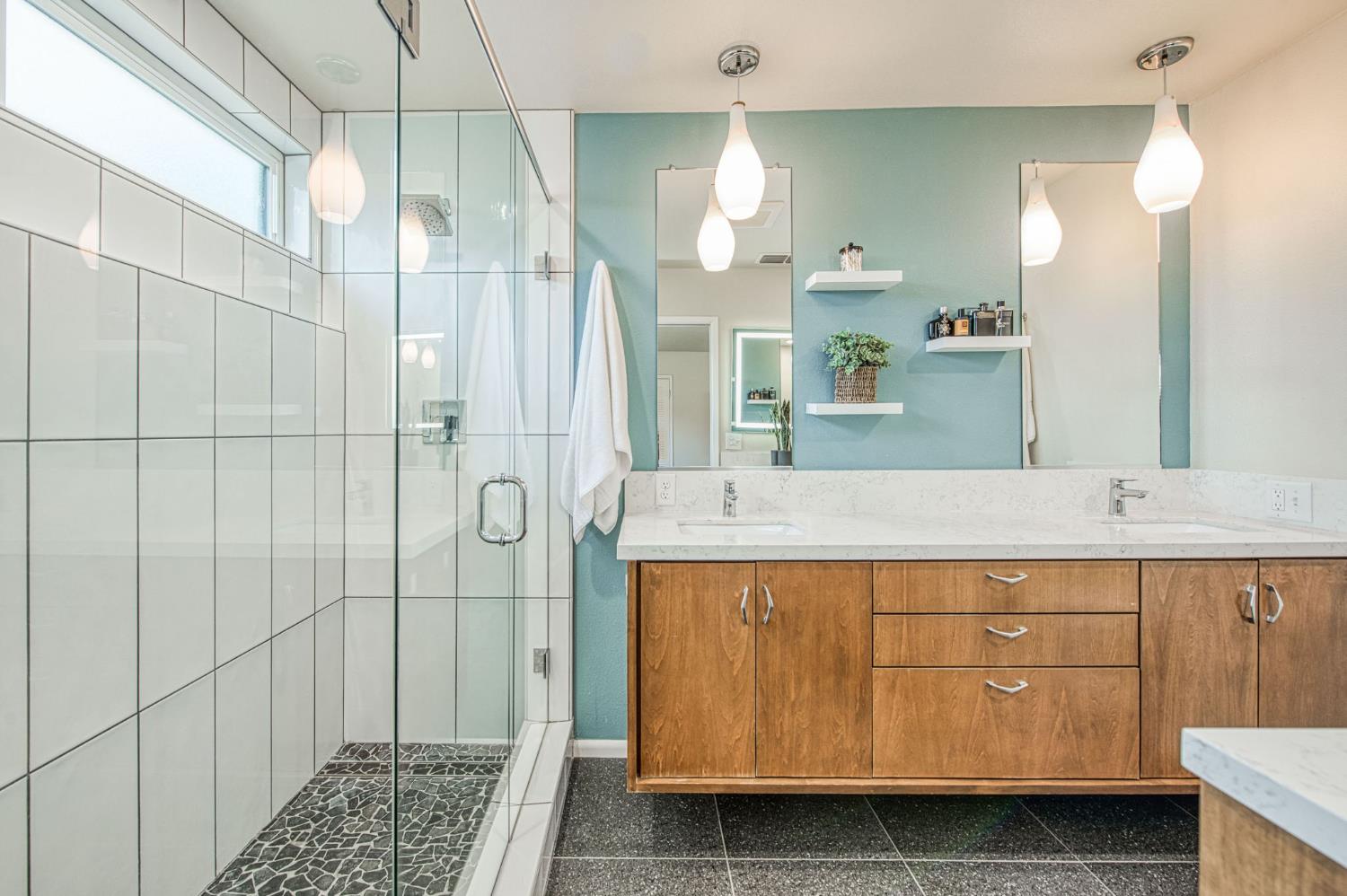 1527 West San Ramon Avenue Fresno, CA 93711 - Photo 30 of 55 a bathroom with a sink a double vanity and shower