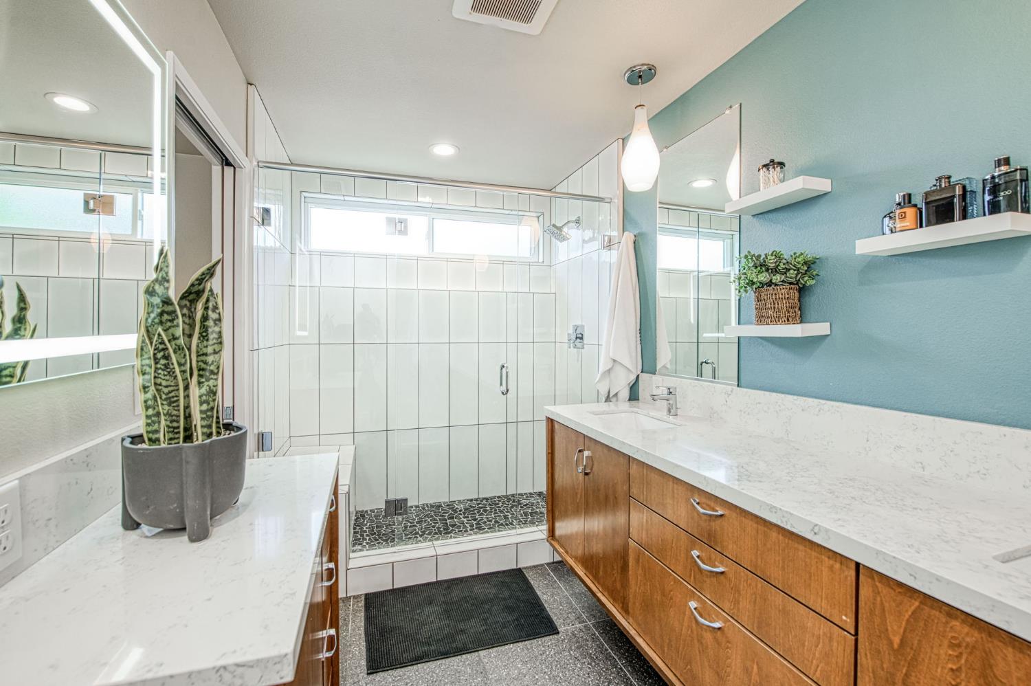 1527 West San Ramon Avenue Fresno, CA 93711 - Photo 31 of 55 a bathroom with a tub sink and mirror