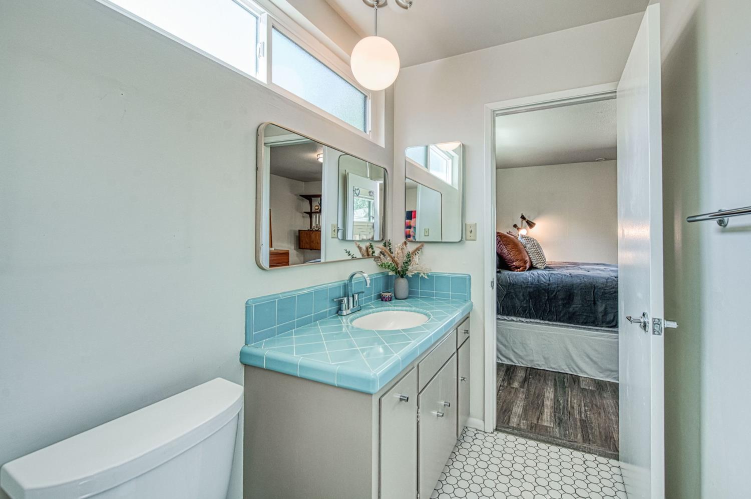 1527 West San Ramon Avenue Fresno, CA 93711 - Photo 34 of 55 a bathroom with a granite countertop sink and a mirror