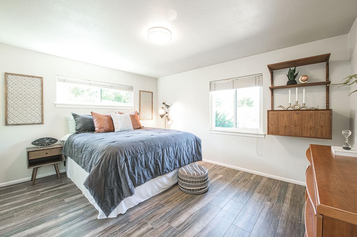 1527 West San Ramon Avenue Fresno, CA 93711 - Photo 35 of 55 a bedroom with a bed and wooden floor