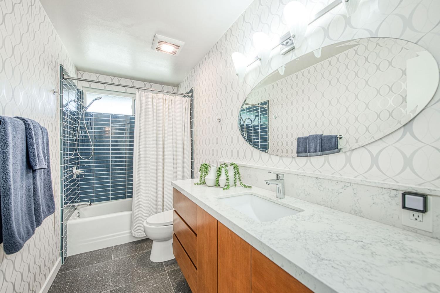 1527 West San Ramon Avenue Fresno, CA 93711 - Photo 39 of 55 a bathroom with a granite countertop sink mirror vanity and toilet