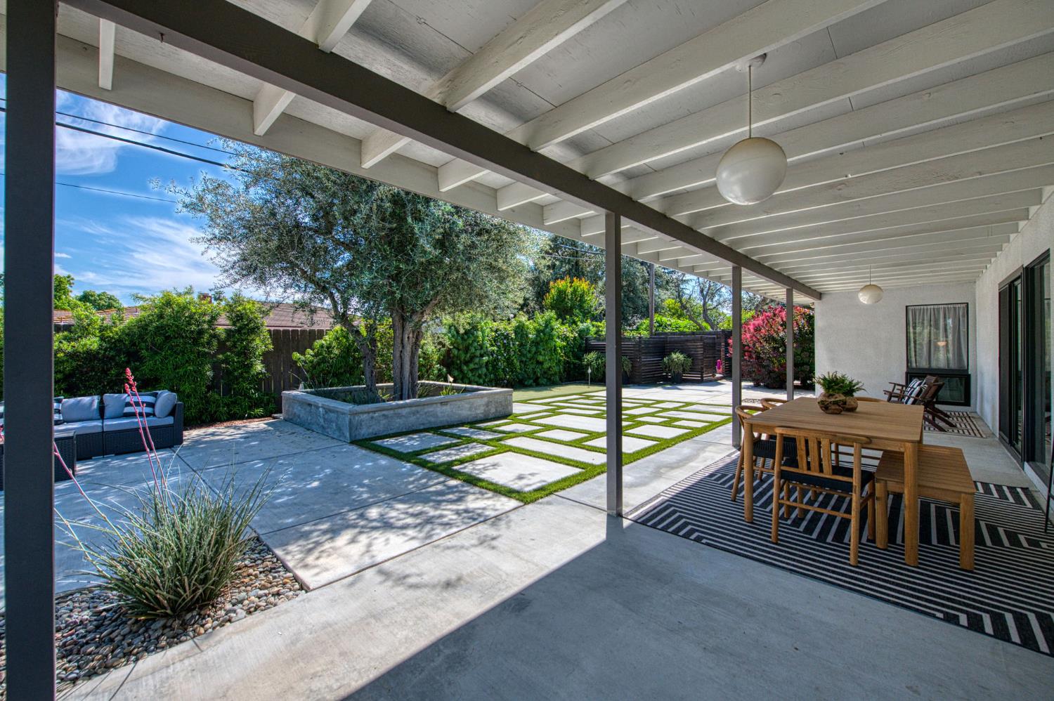 1527 West San Ramon Avenue Fresno, CA 93711 - Photo 40 of 55 a view of a patio with table and chairs potted plants with floor to ceiling window and potted plants