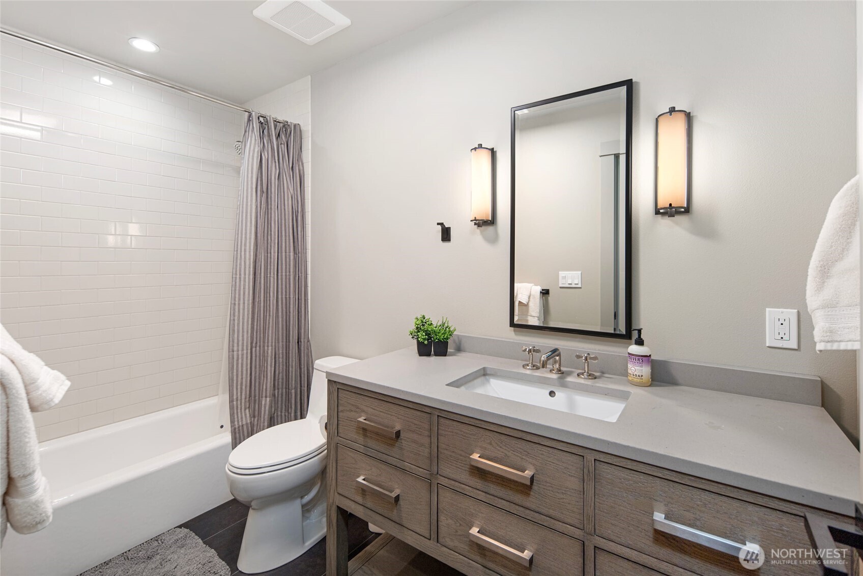 1248 Kanaka Bay Road Friday Harbor, WA 98250 - Photo 24 of 37 a bathroom with a granite countertop sink toilet a large mirror a bathtub and shower