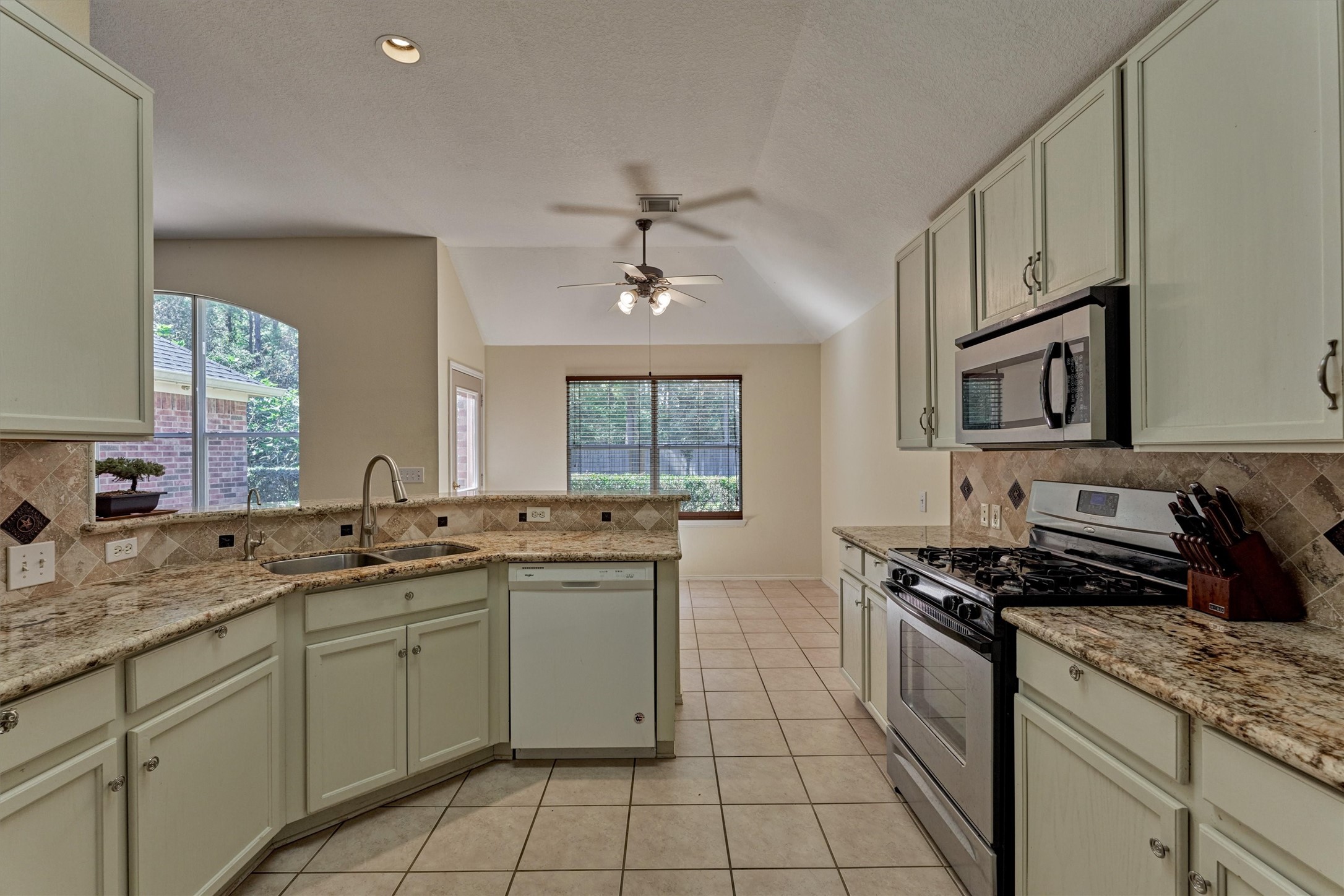 20835 Louetta Oak Drive Spring, TX 77388 - Photo 6 of 37 a kitchen with stainless steel appliances a sink stove and cabinets