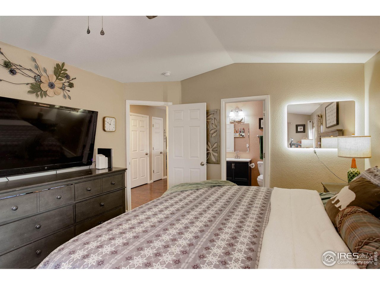 1205 Trail Ridge Road Longmont, CO 80504 - Photo 12 of 23 a bedroom with a bed and a flat screen tv