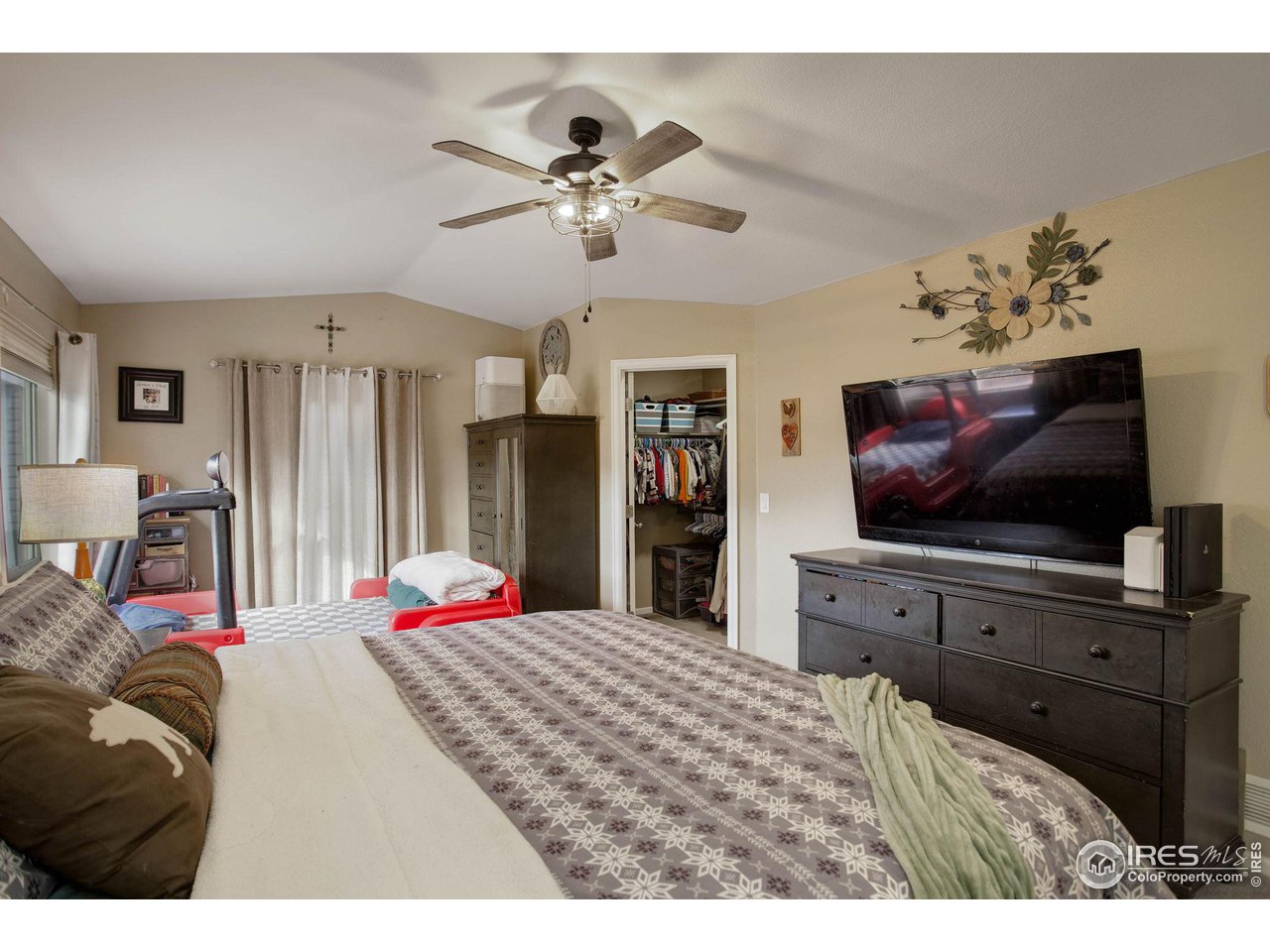 1205 Trail Ridge Road Longmont, CO 80504 - Photo 15 of 23 a bedroom with a bed and a flat screen tv