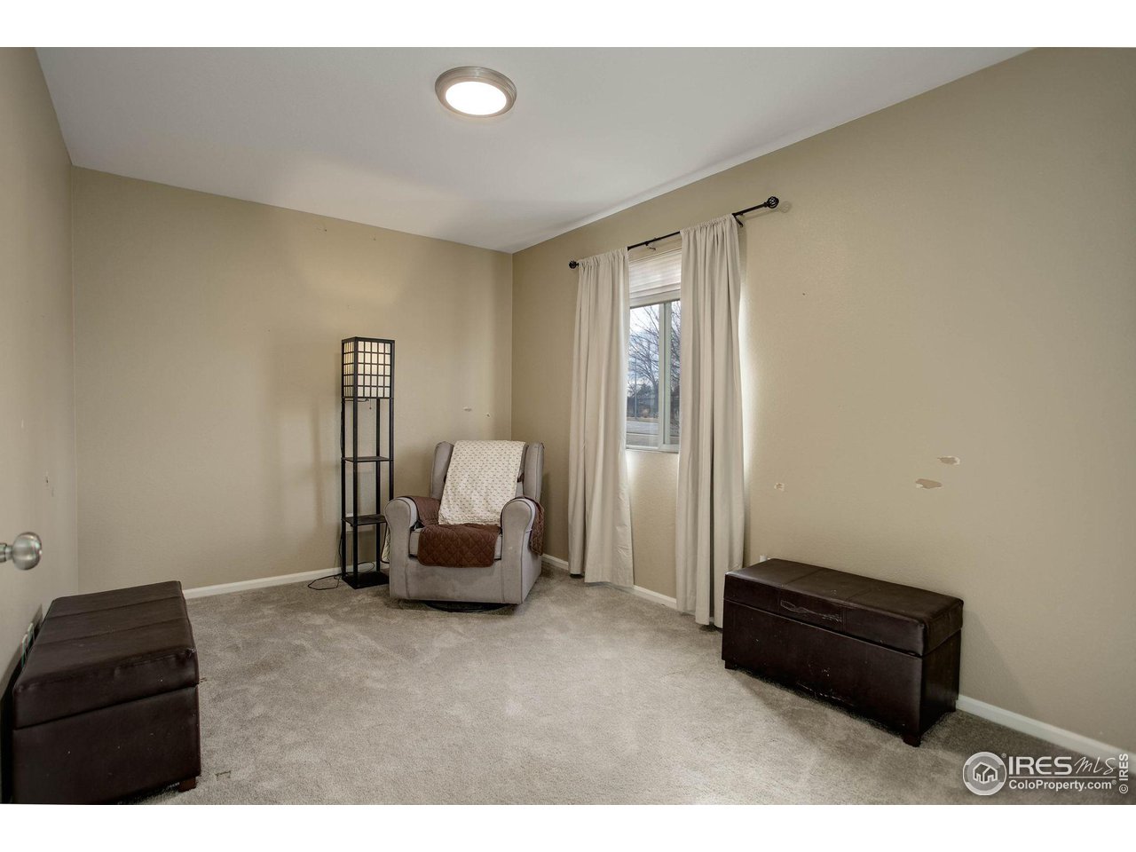 1205 Trail Ridge Road Longmont, CO 80504 - Photo 19 of 23 a living room with a couch and a chair