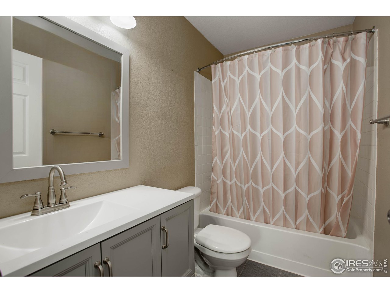 1205 Trail Ridge Road Longmont, CO 80504 - Photo 20 of 23 a bathroom with a sink and a mirror