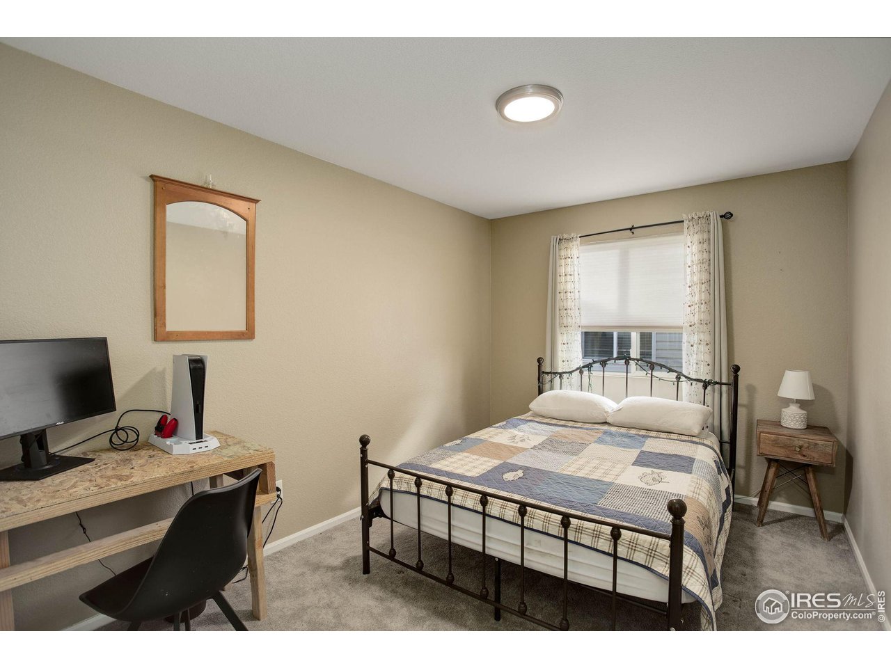 1205 Trail Ridge Road Longmont, CO 80504 - Photo 21 of 23 a bedroom with a bed and a table