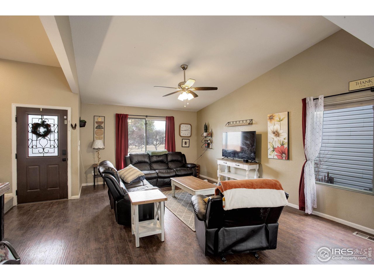 1205 Trail Ridge Road Longmont, CO 80504 - Photo 3 of 23 a living room with furniture and a wooden floor