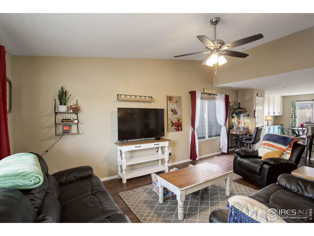 1205 Trail Ridge Road Longmont, CO 80504 - Photo 4 of 23 a living room with furniture and a flat screen tv