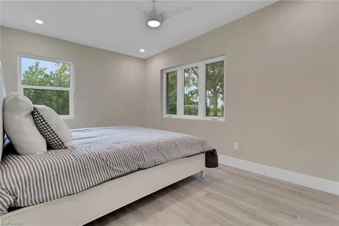 a bedroom with a large bed and a window