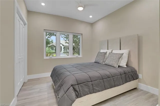 a bedroom with a large bed and a window