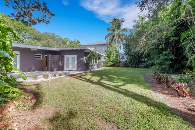 a swimming pool with outdoor seating and yard
