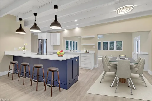 a dining room with wooden floor and chandelier