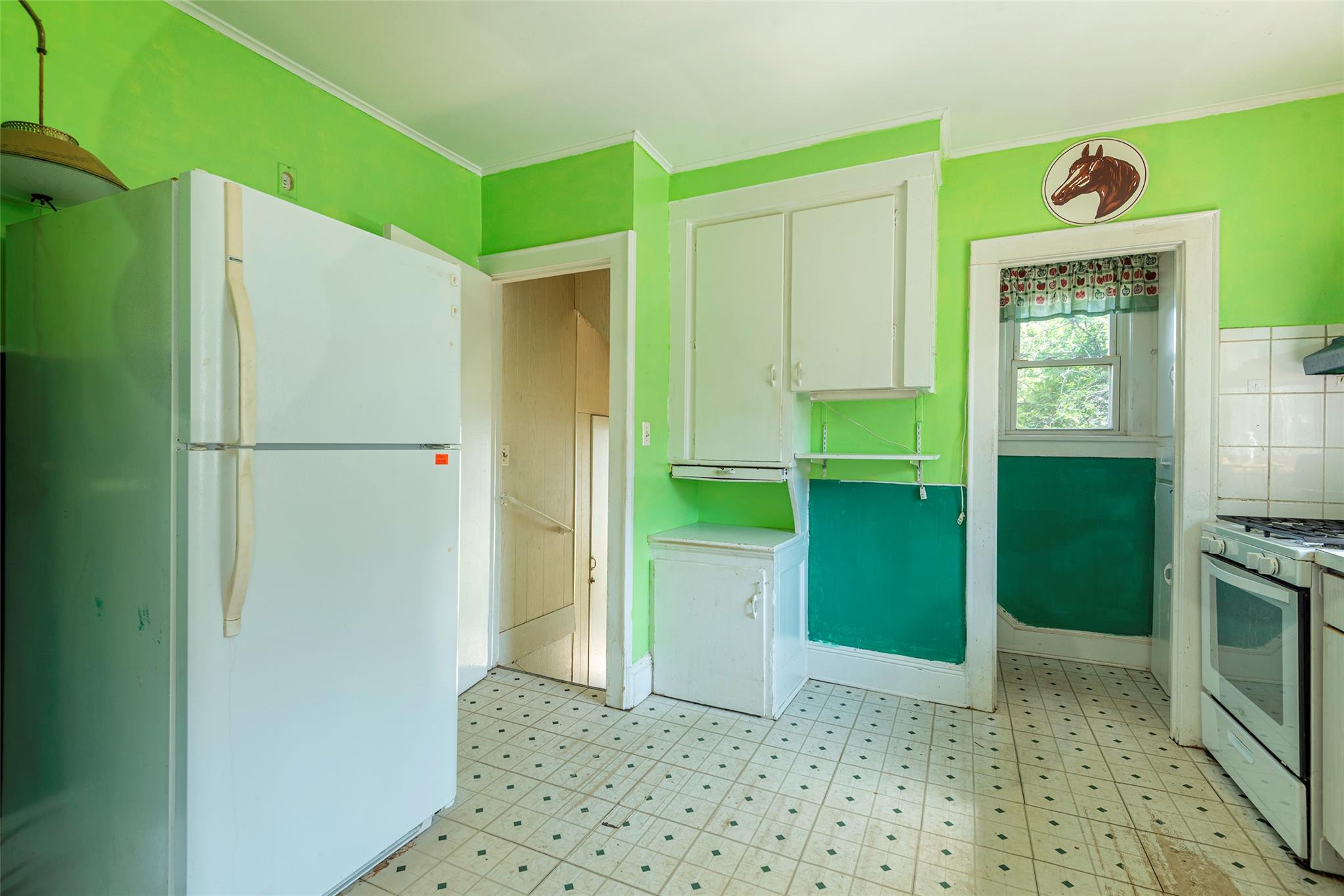 2 Florence Street Baldwin, NY 11510 - Photo 13 of 38 Kitchen featuring white appliances, light flooring, white cabinets, and crown molding