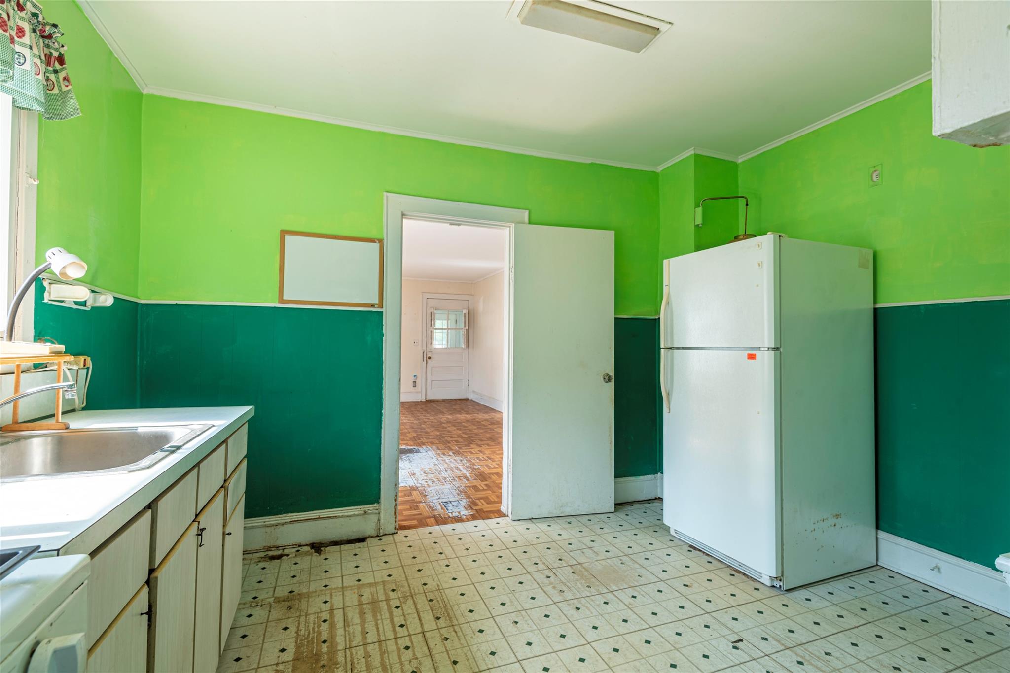 2 Florence Street Baldwin, NY 11510 - Photo 15 of 38 Kitchen featuring freestanding refrigerator, light floors, crown molding, light countertops, and range