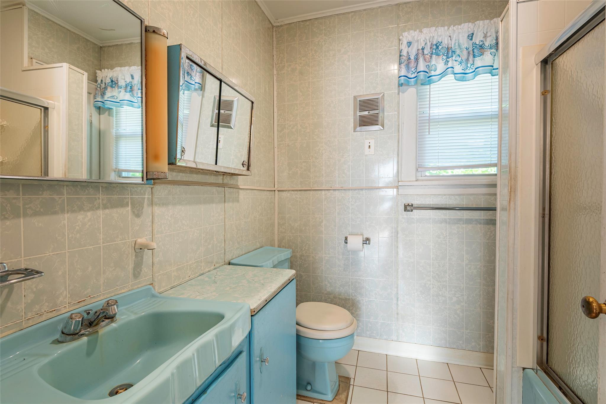 2 Florence Street Baldwin, NY 11510 - Photo 21 of 38 Full bath with ornamental molding, an enclosed shower, tile patterned flooring, vanity, and tile walls