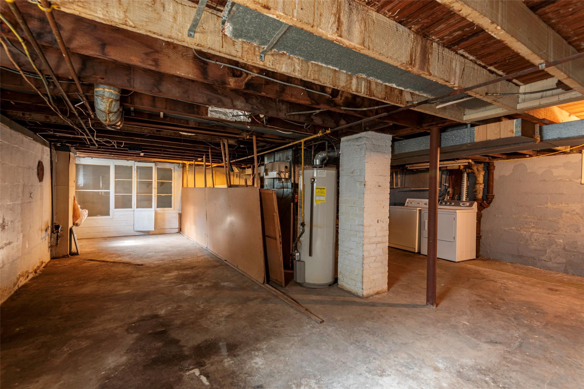 2 Florence Street Baldwin, NY 11510 - Photo 30 of 38 Unfinished below grade area featuring water heater and washing machine and dryer
