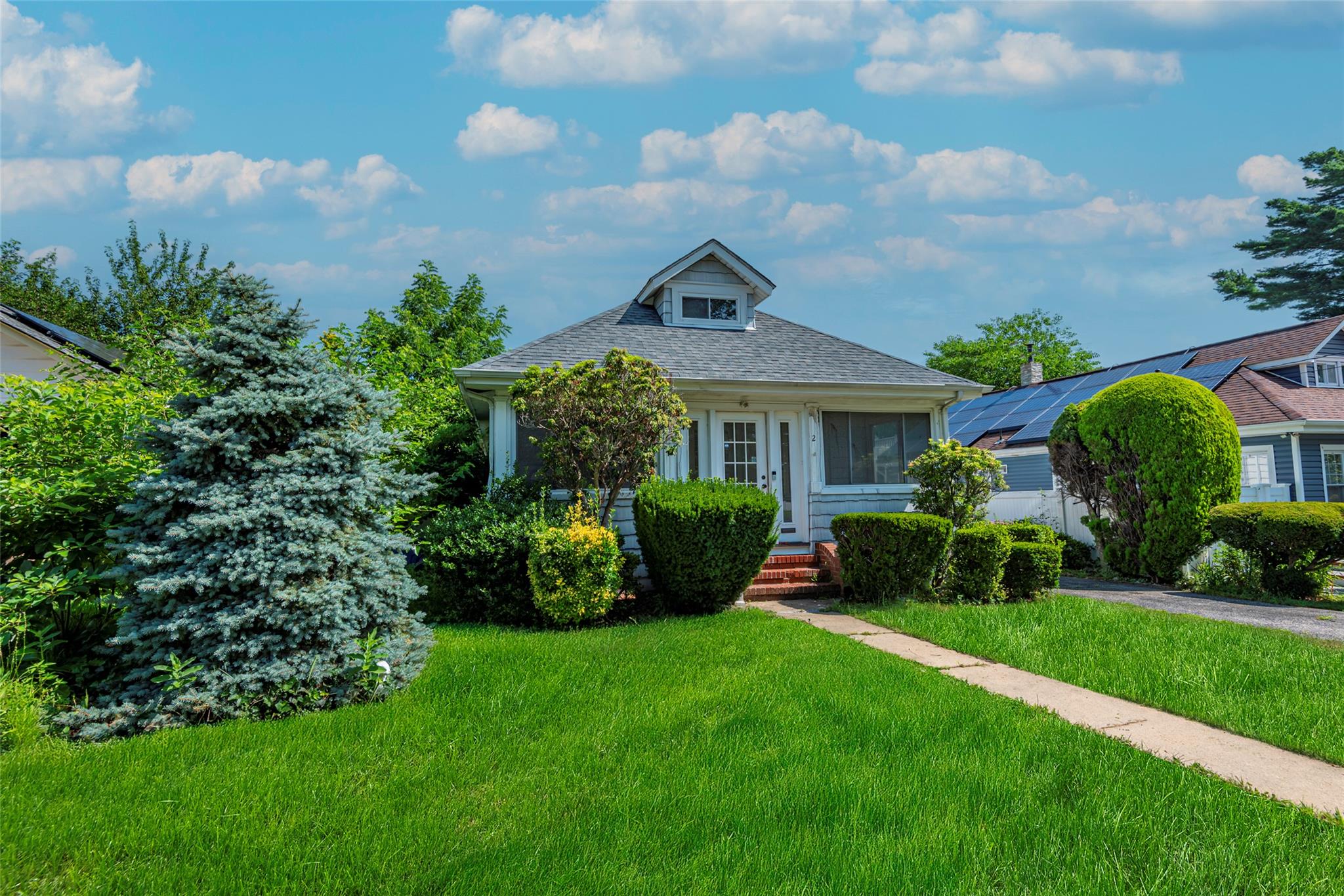 2 Florence Street Baldwin, NY 11510 - Photo 3 of 38 Bungalow-style house with a front lawn and roof with shingles