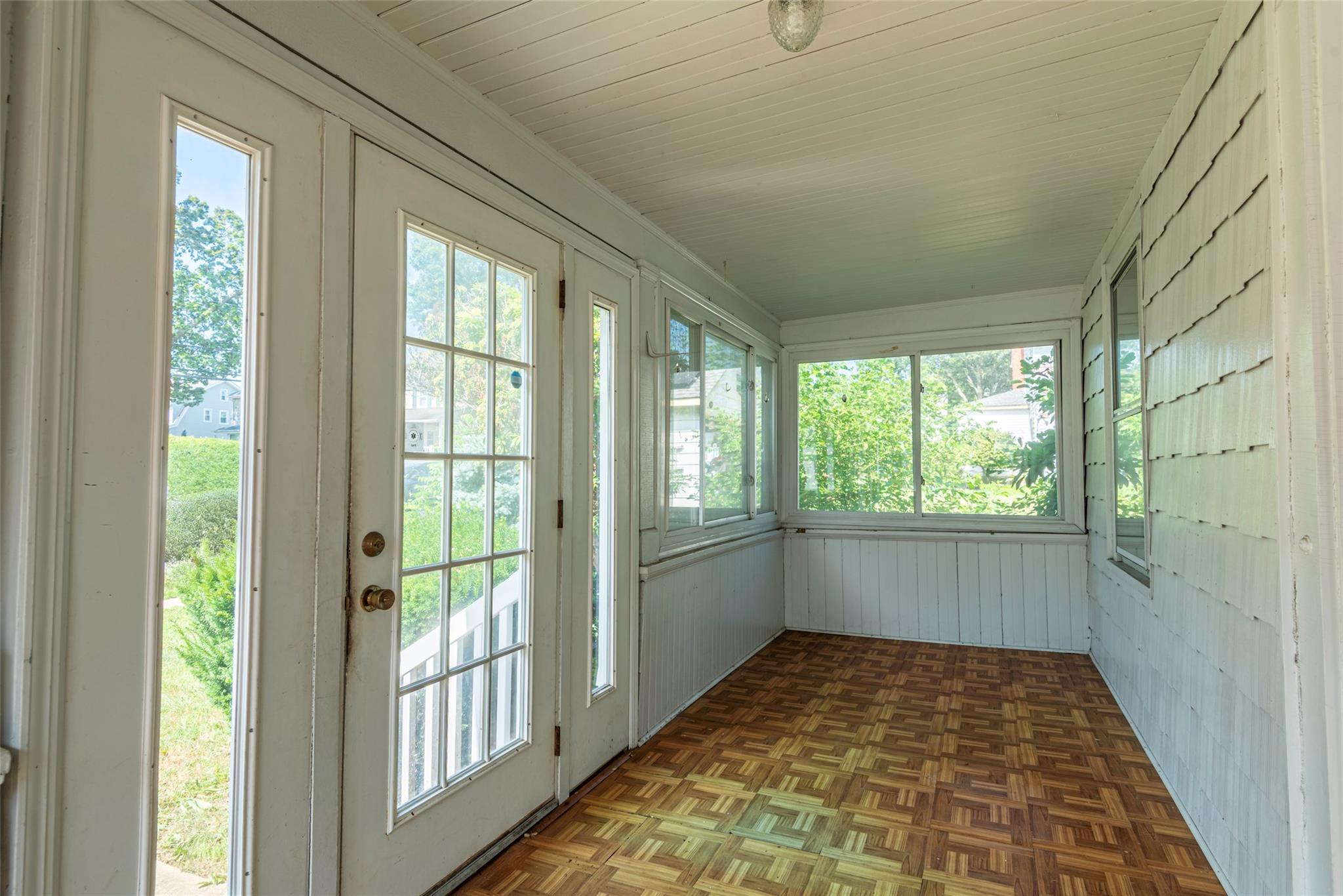 2 Florence Street Baldwin, NY 11510 - Photo 4 of 38 Unfurnished sunroom featuring french doors and healthy amount of natural light
