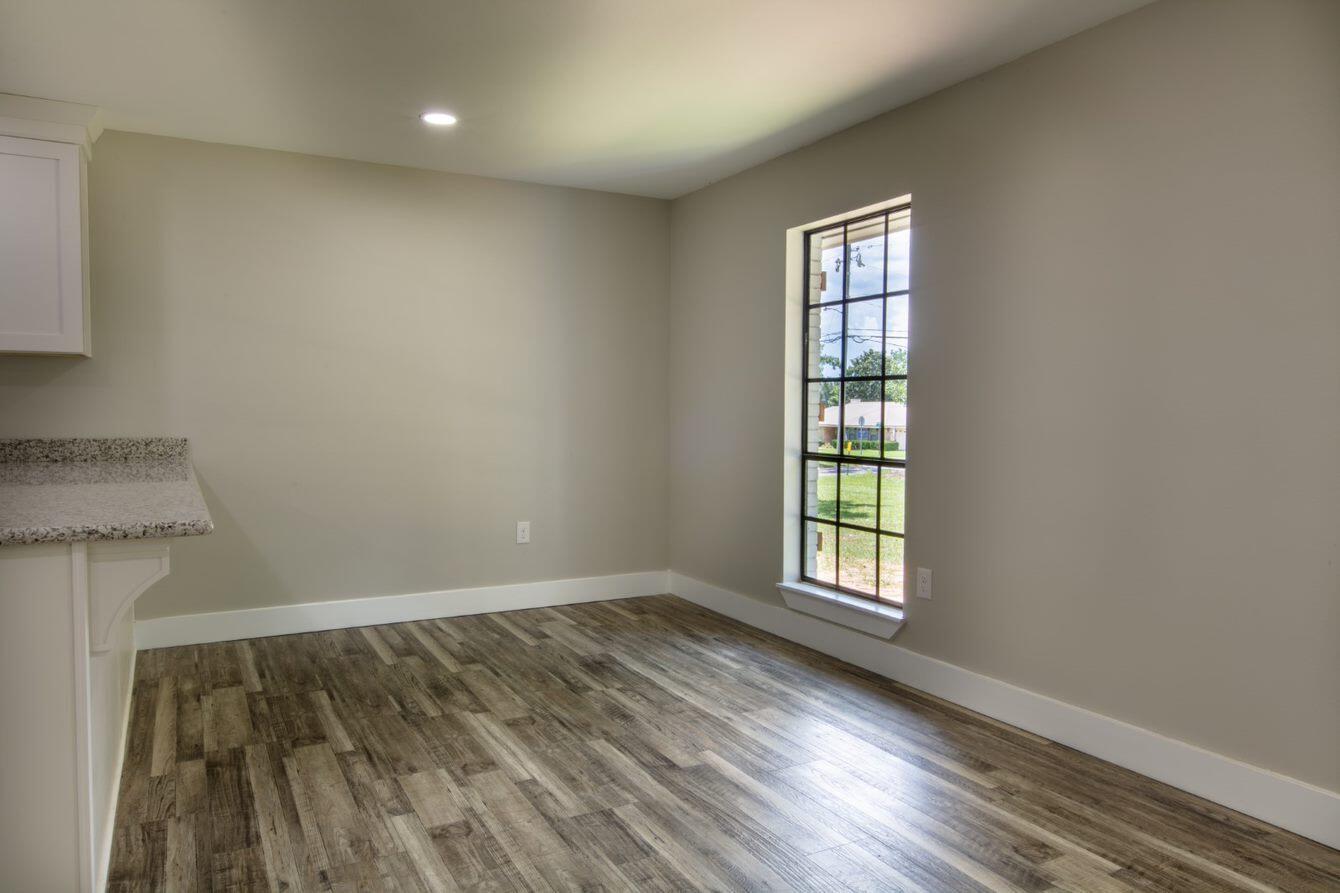 1414 Red Oak Drive Crestview, FL 32539 - Photo 8 of 34 an empty room with wooden floor and windows