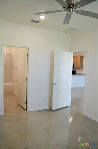 an empty room with closet and windows
