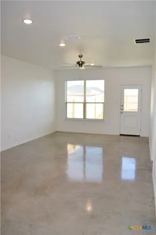 an empty room with windows and entrance