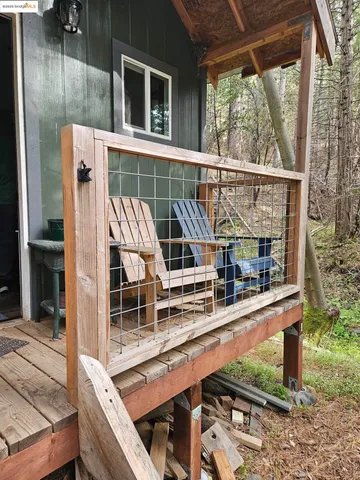 a view of balcony with a large window and wooden fence