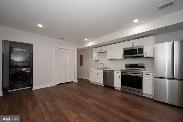 a view of a kitchen with a sink stove refrigerator and microwave