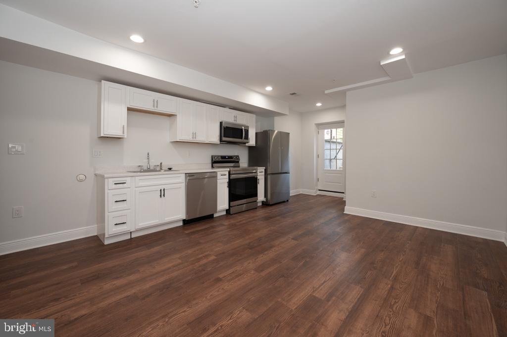 3321 11th Street Northwest, Unit 1 Washington, DC 20010 - Photo 2 of 10 a kitchen with stainless steel appliances a sink cabinets and wooden floor