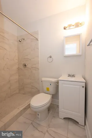 a bathroom with a toilet sink and a shower