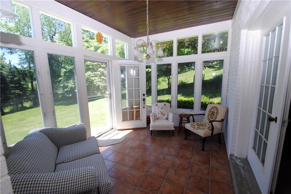 127 McCoy Place Road Sewickley, PA 15143 - Photo 8 of 23 This peaceful sun room is accessed from the kitchen and the family room. Screened and ready to enjoy with a good book on a summer night.