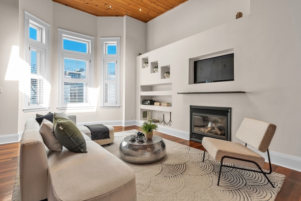 a living room with furniture fireplace and window