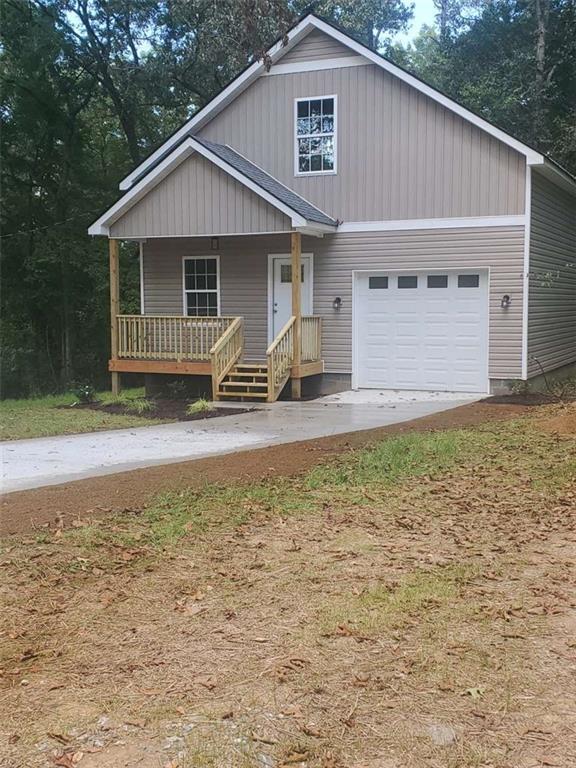 a front view of a house with yard and seating space