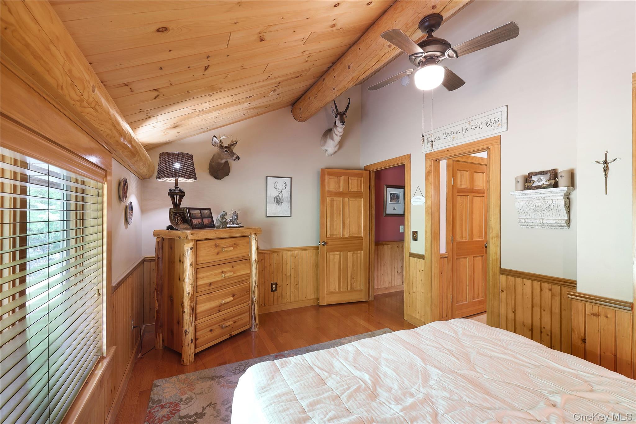 25 Cauthers Road Fallsburg, NY 12789 - Photo 23 of 27 a bedroom with a bed and a chandelier