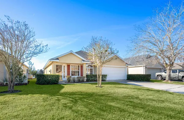 a front view of house with yard and green space