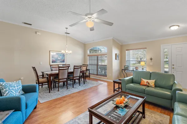 a living room with furniture and a chandelier