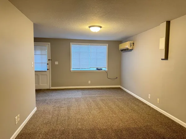 an empty room with a empty space and windows