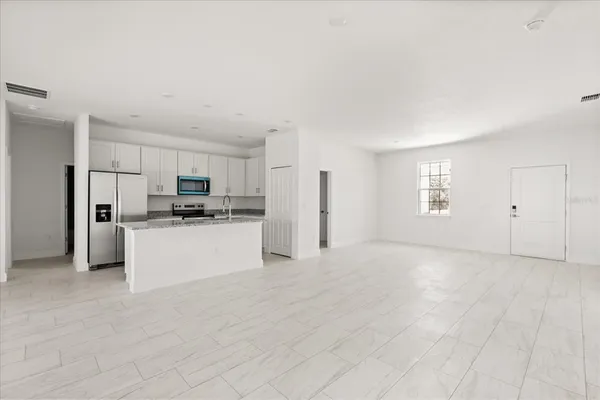 a kitchen with granite countertop a sink and a stove top oven