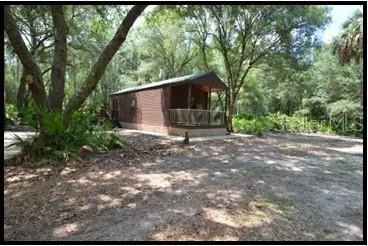 a kitchen with a sink a window and cabinets