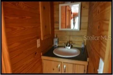 a view of a roof deck with table and chairs a barbeque with wooden fence