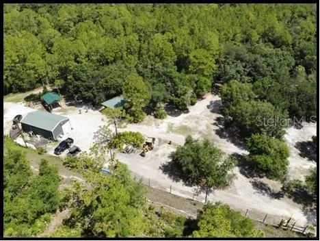 a view of a house with backyard porch and sitting area