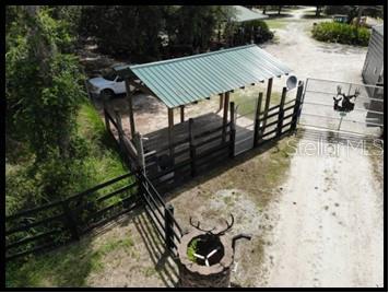 7019 Crooked Creek Lane Zolfo Springs, FL 33890 - Photo 22 of 51 a view of a roof deck with table and chairs a barbeque with wooden fence