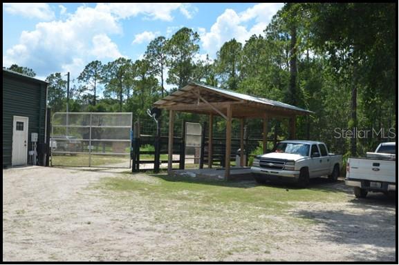 7019 Crooked Creek Lane Zolfo Springs, FL 33890 - Photo 24 of 51 a view of a house with backyard porch and sitting area