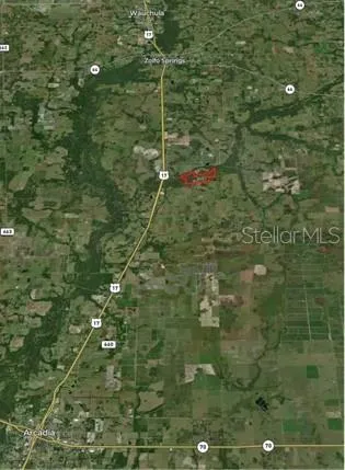 a view of a house with a yard and tree