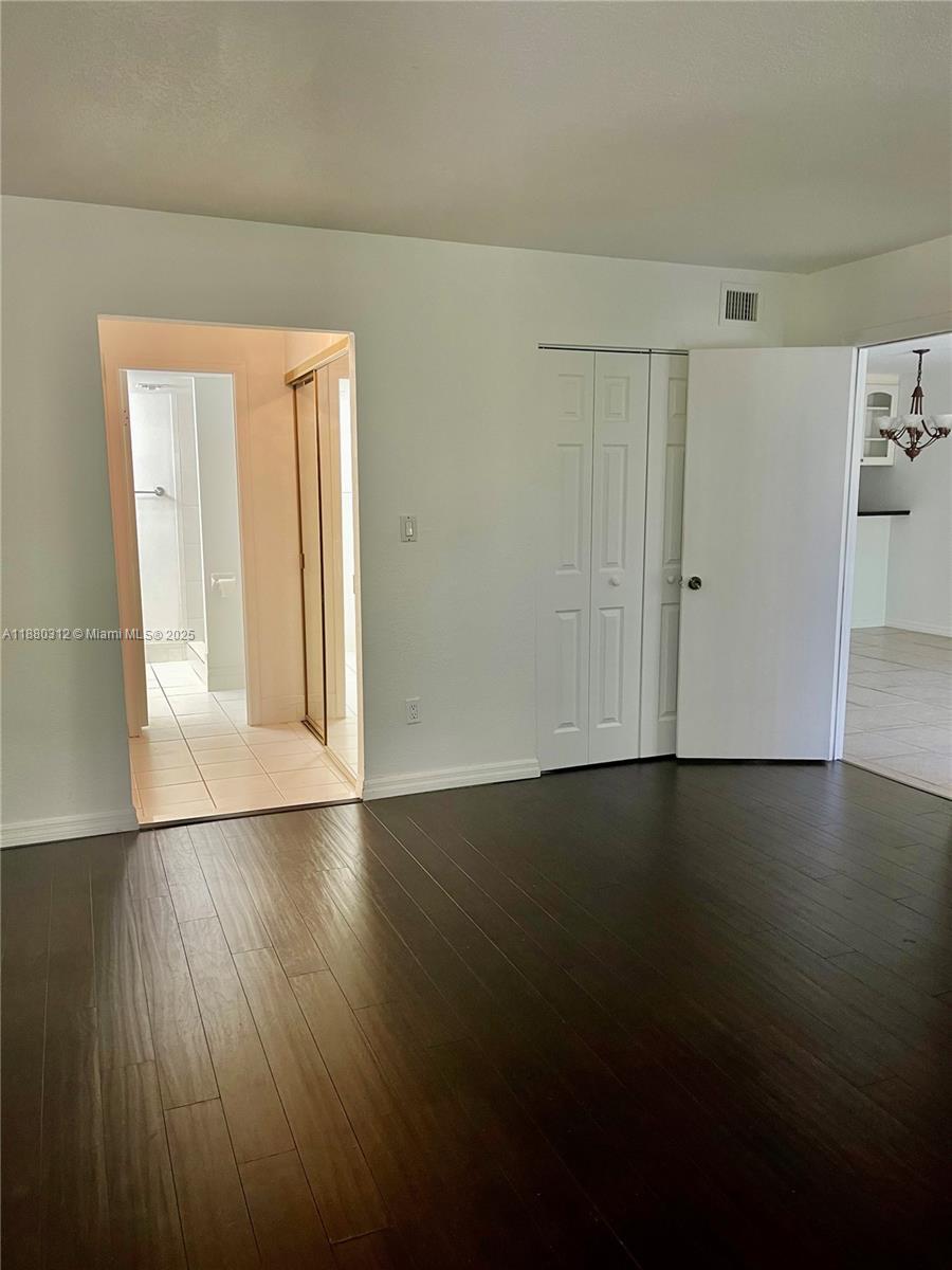 6800 Cypress Road, Unit 408 Plantation, FL 33317 - Photo 11 of 25 a view of an empty room with wooden floor and closet