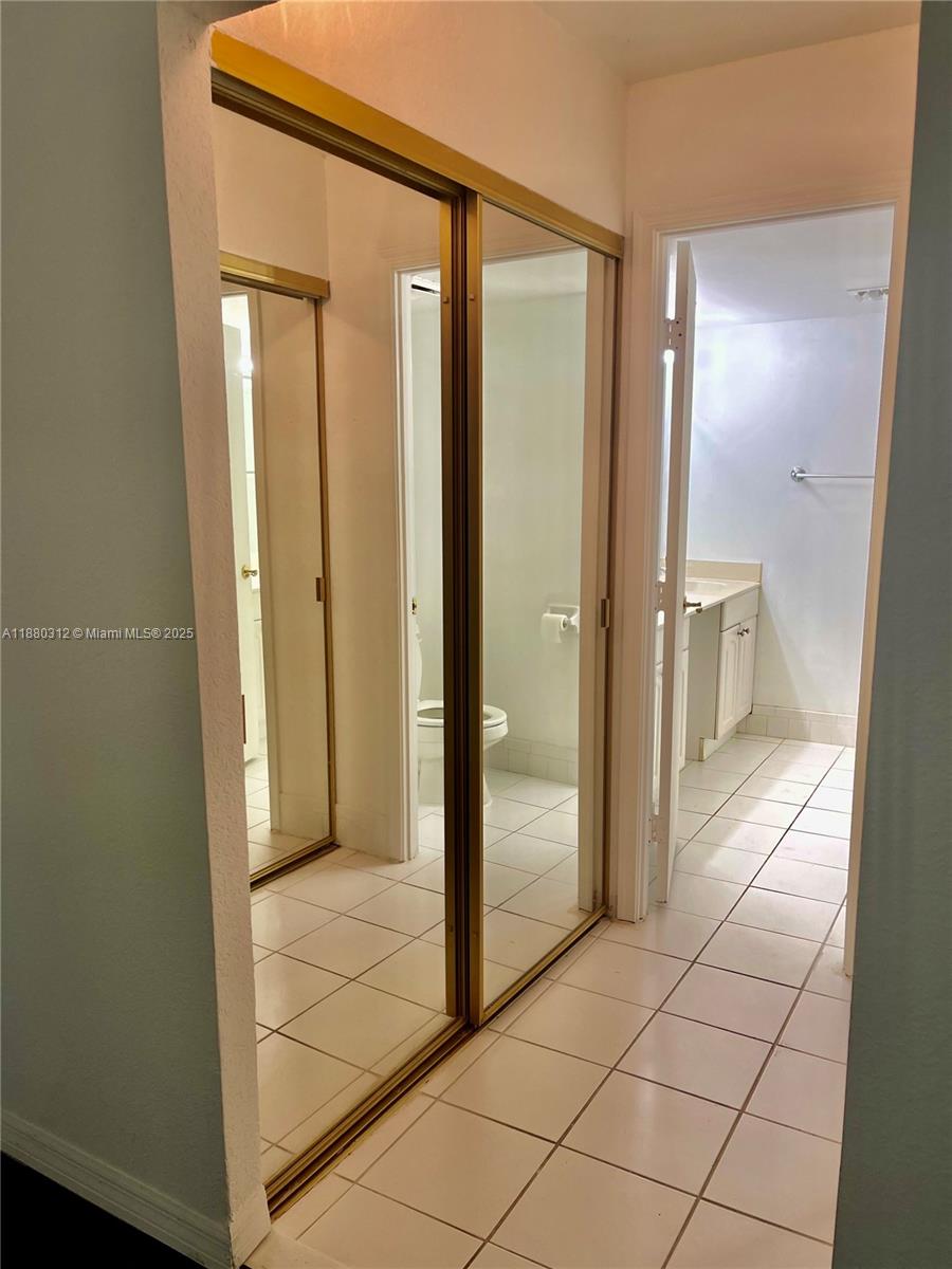 6800 Cypress Road, Unit 408 Plantation, FL 33317 - Photo 12 of 25 a view of a bathroom with mirror