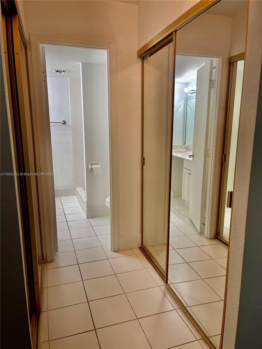 6800 Cypress Road, Unit 408 Plantation, FL 33317 - Photo 13 of 25 a bathroom with a glass door shower and a sink